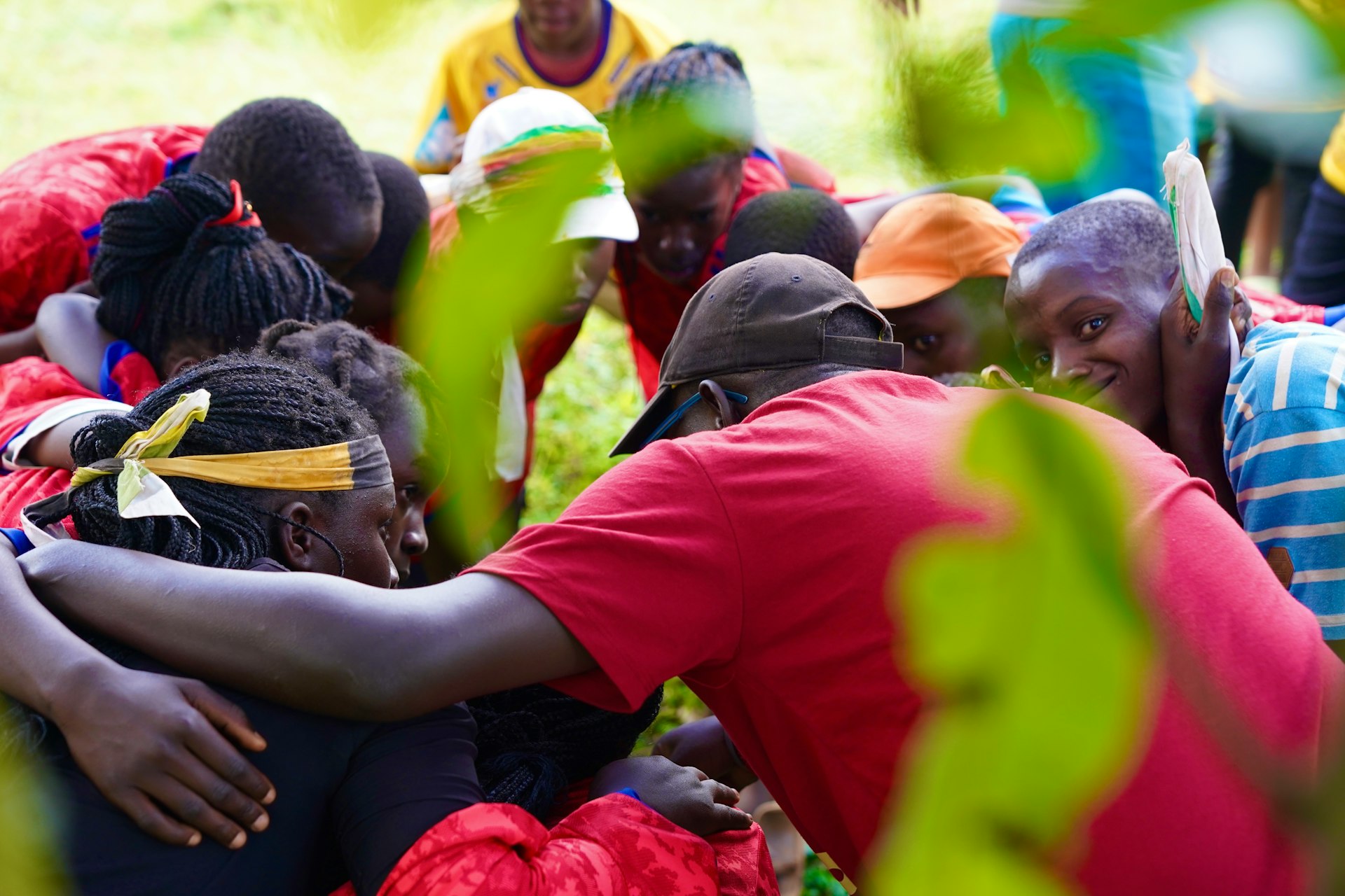 People of diverse backgrounds share a warm embrace.